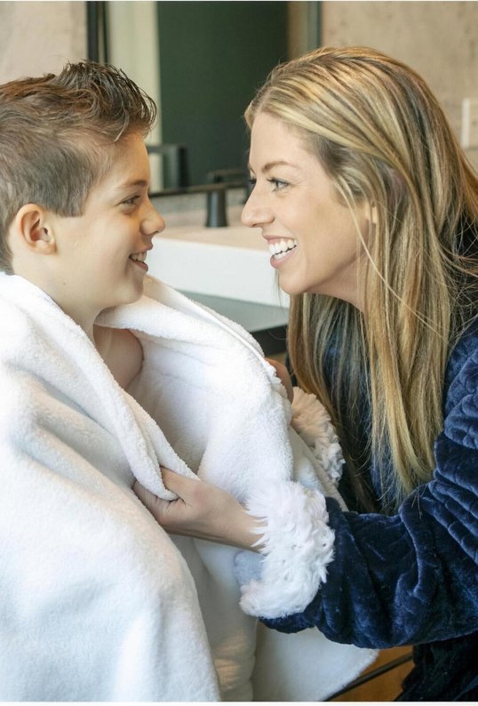 Mom wrapping her son in a soft, warm towel