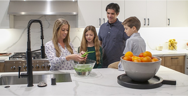 A family preparing food together in a kitchen