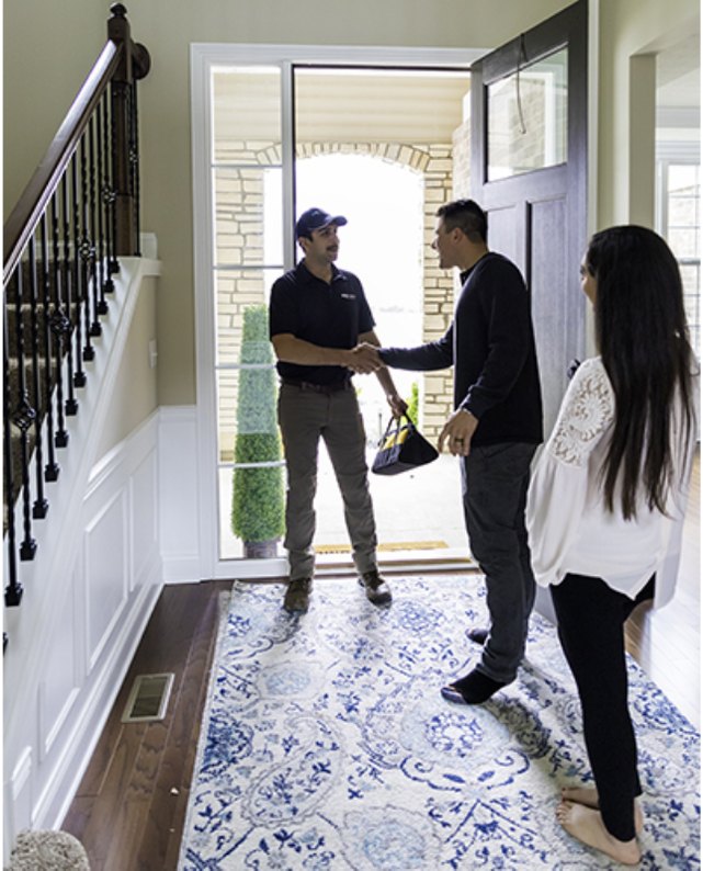 Kinetico technician greeting homeowners at their front door