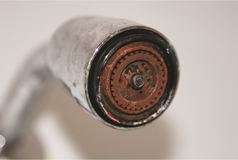 Shower head with orange iron staining