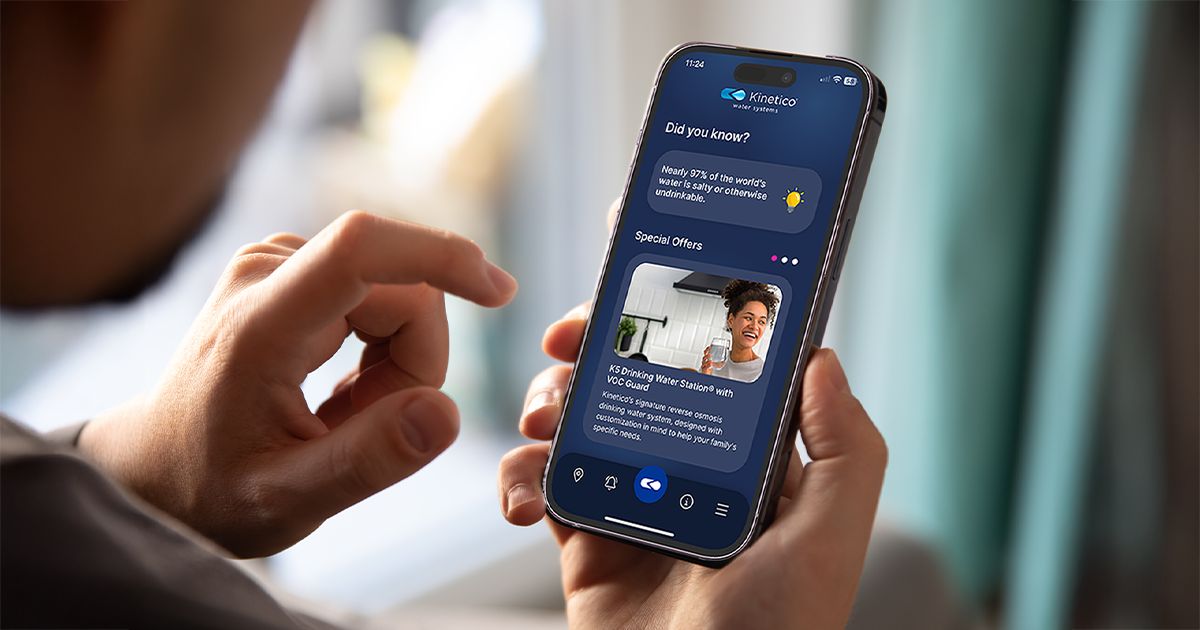 A homeowner checking the Kinetico App on a phone