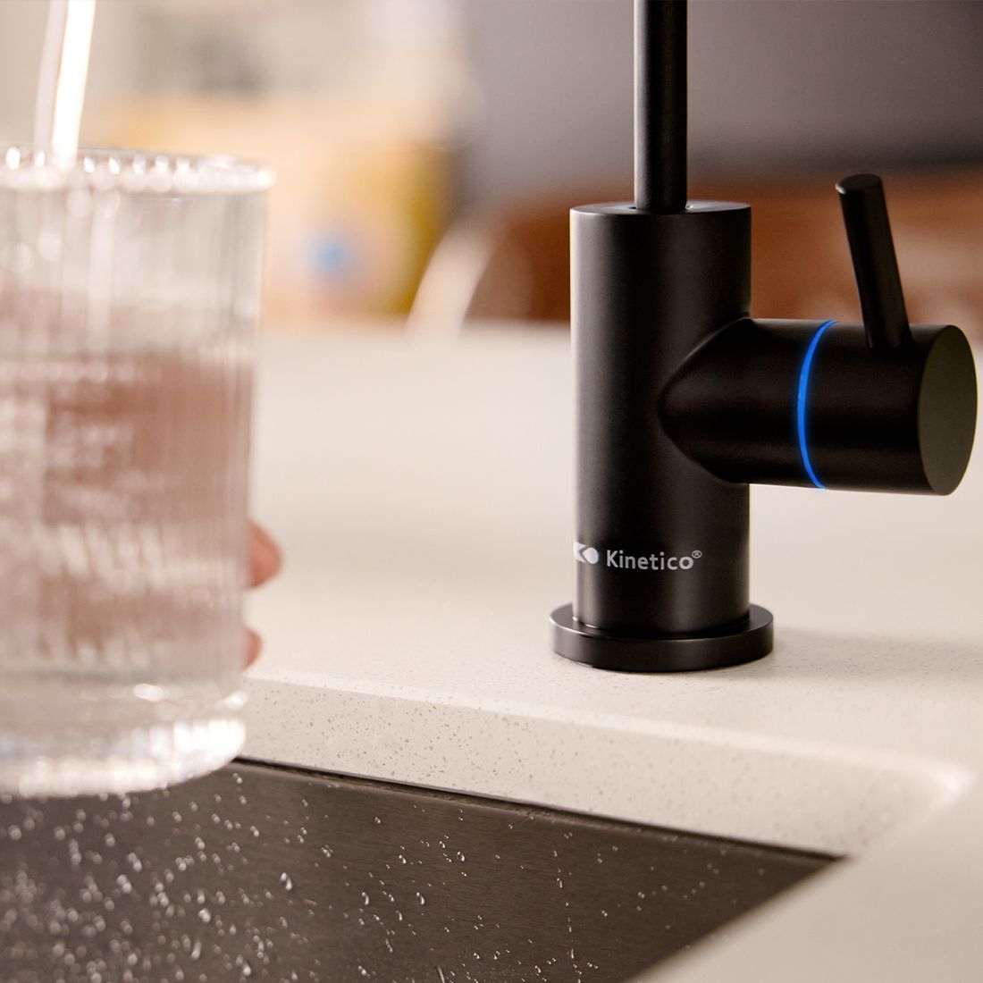 A glass beside a Kinetico drinking water faucet