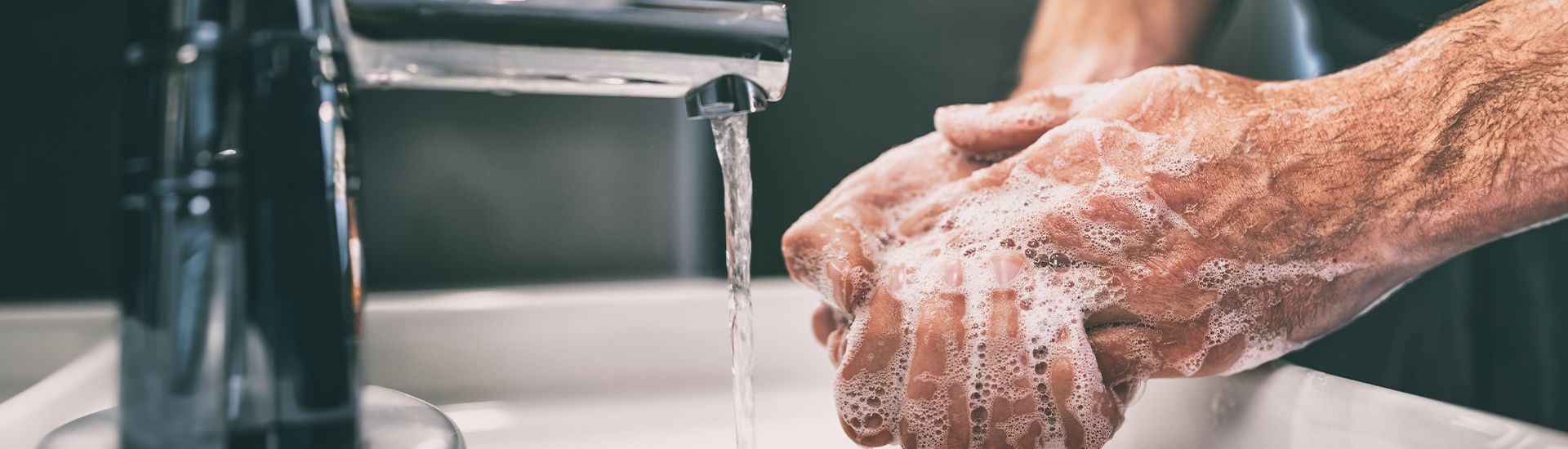 Hands lathering easily under a running faucet