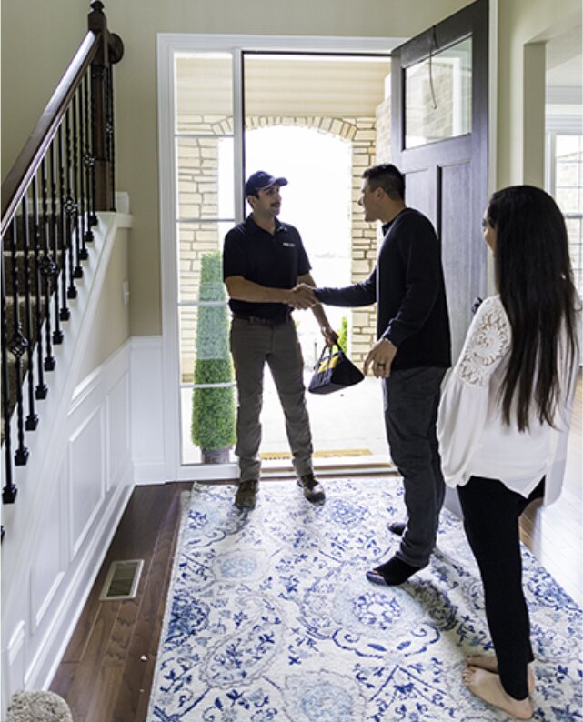 Dan Cardinal greeting a homeowner at the front door