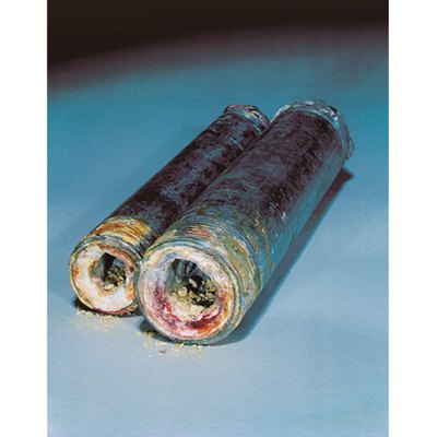 Corroded pipes showing scale and blue-green buildup