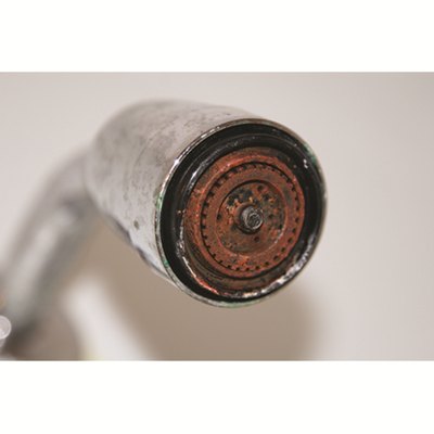 Iron and rust buildup crusted on a household fixture