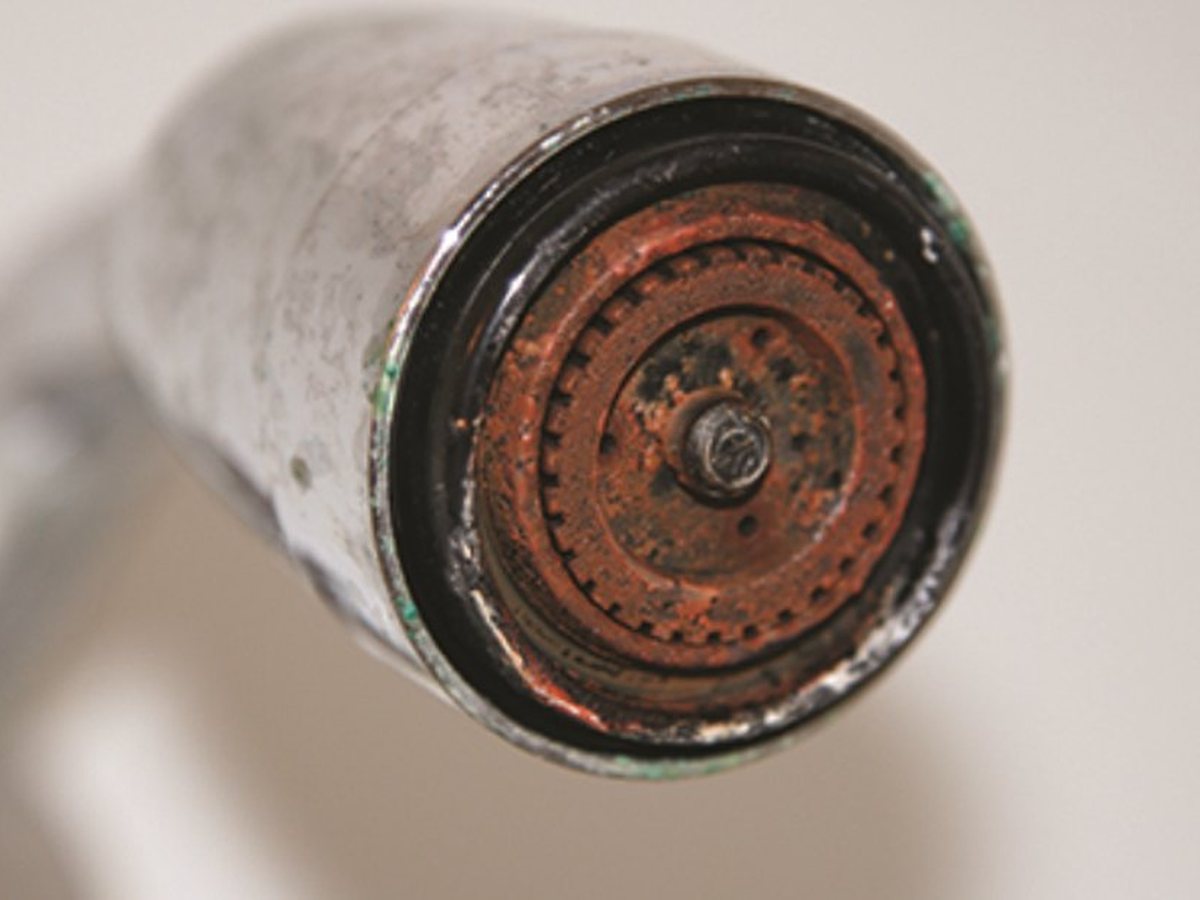 Iron and rust buildup crusted on a household fixture