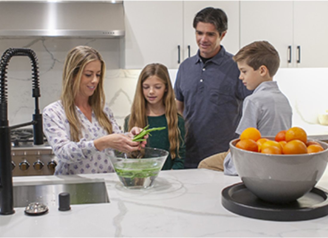 A family preparing dinner together in a bright kitchen