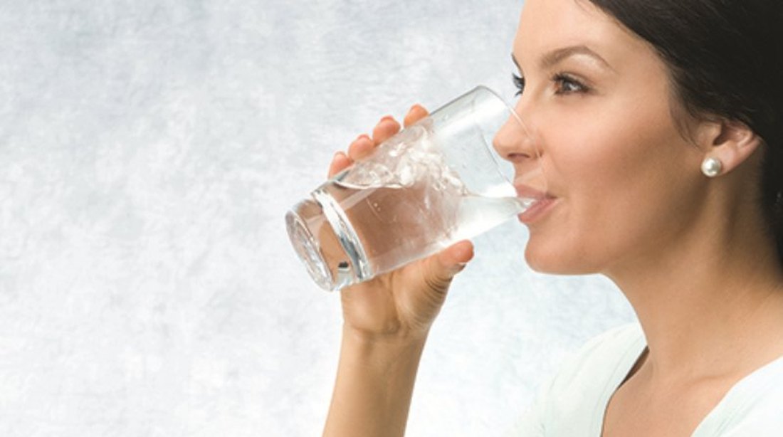 Filling a glass of filtered drinking water