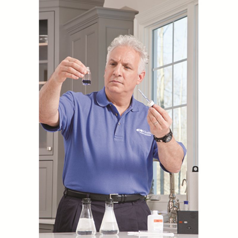 A water professional running a test at the kitchen sink