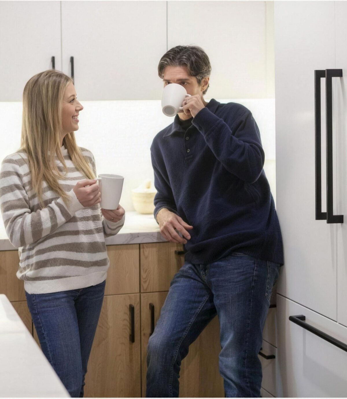 Couple enjoying morning coffee in a bright kitchen