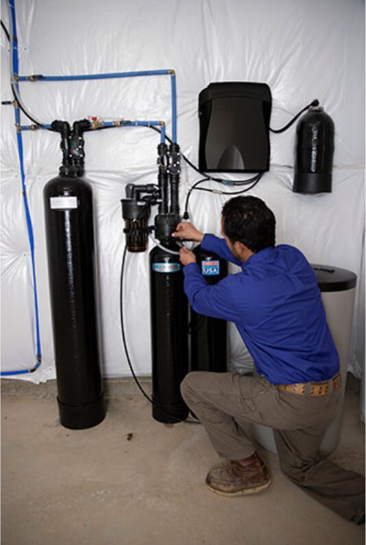 Kinetico technician completing a basement softener installation