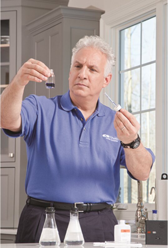 Kinetico water specialist running a test at a kitchen counter